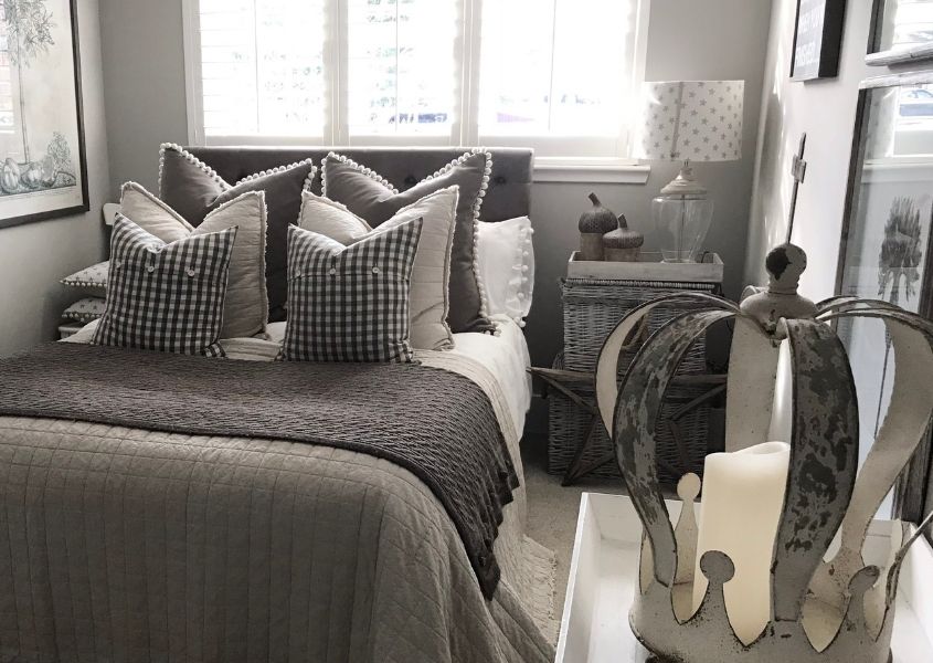 Double bed with grey covers and cushions