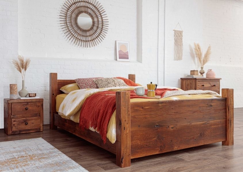 solid wood bed in reclaimed wood with yellow and orange covers