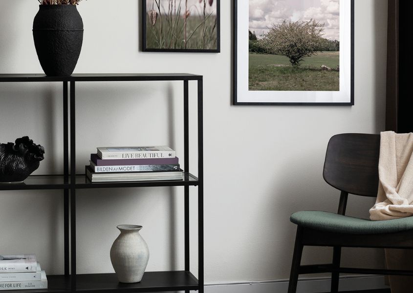 industrial bookcase with white and black vases