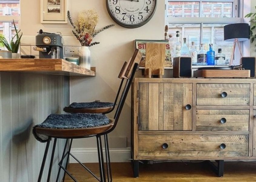 Reclaimed wood industrial sideboard with two industrial bar stools under breakfast bar