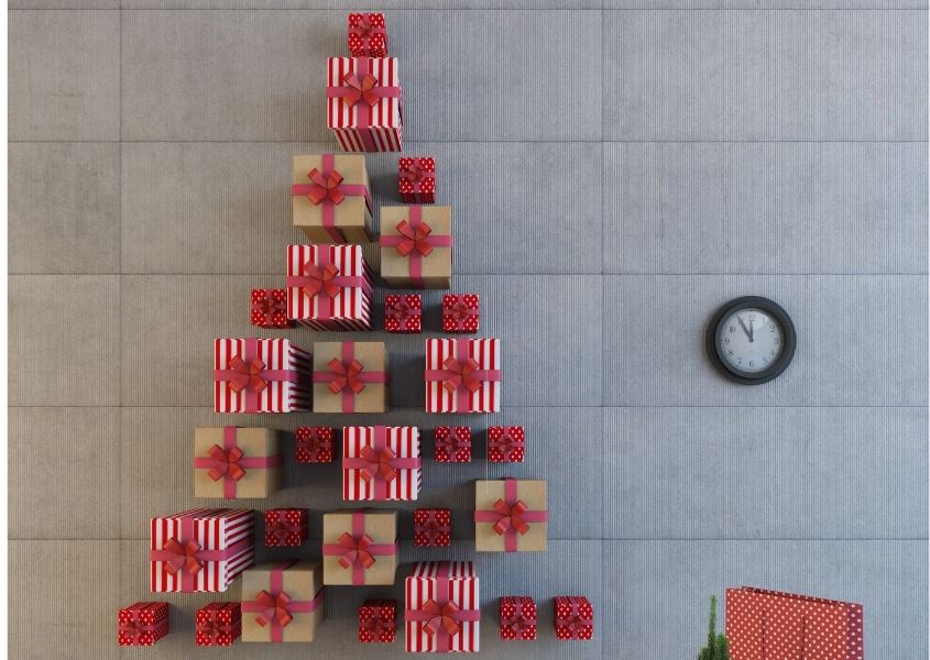 Wrapped presents against a wall in shape of a Christmas tree
