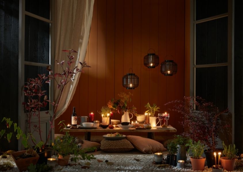 solid wood dining table styled with autumnal accessories and lighting