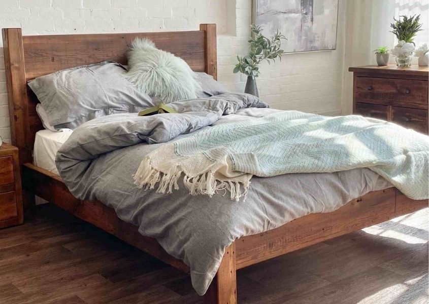 Reclaimed wood bed with grey covers and blanket