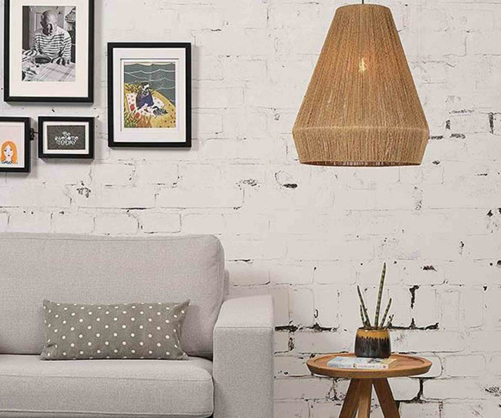 Natural hanging pendant next to grey sofa