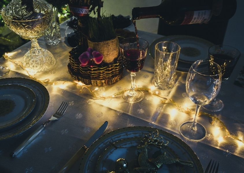 Close up of dining table with fairy lights lit up on the table