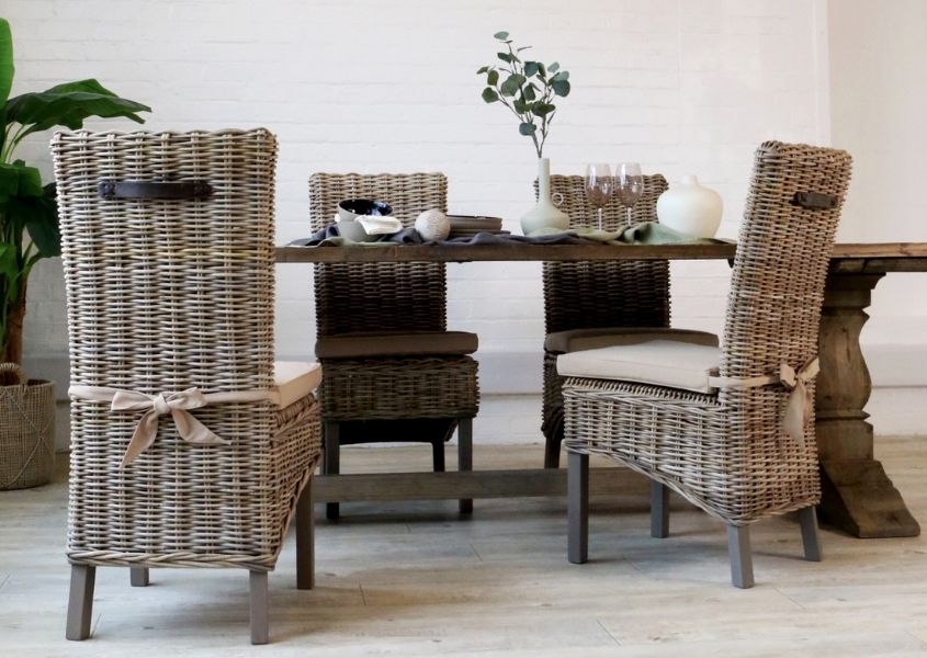 rattan dining chairs around reclaimed wood dining table