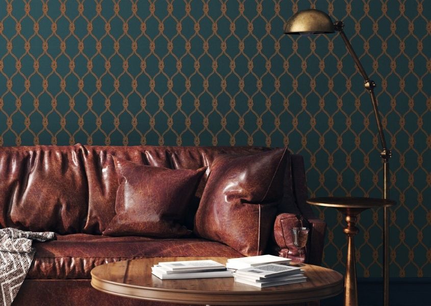 dark geometric wallpaper with brown leather sofa and wooden coffee table