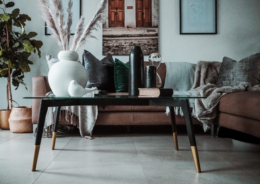 black rustic coffee table with brown leather corner sofa