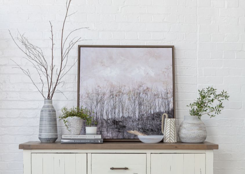 display of vases and print on reclaimed wood sideboard