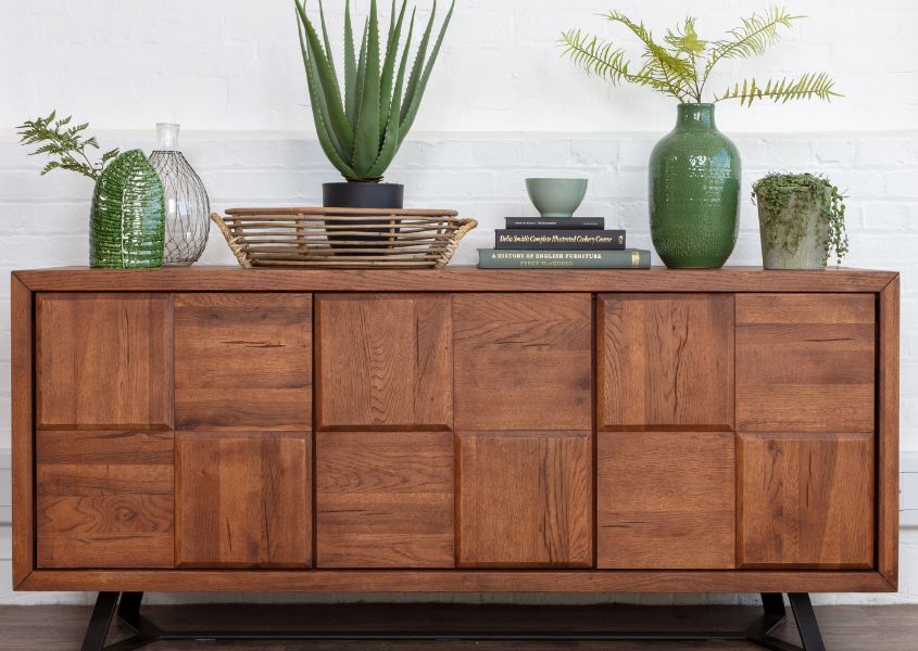 oak sideboard with square panelled front and green accessories