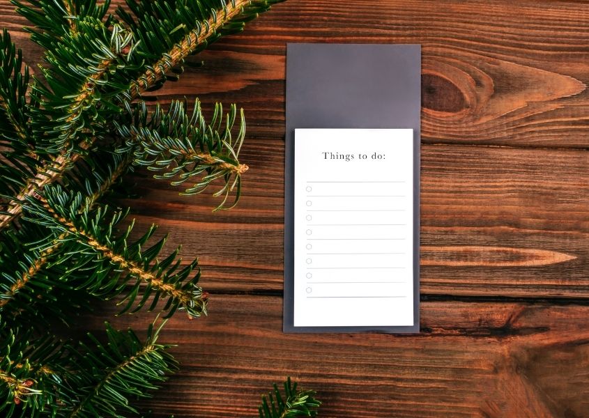 Rustic wood background with pine needles and to do list