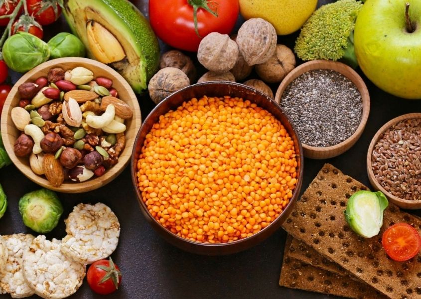 Close up of selection of pulses, beans, nuts, fruits and vegetables