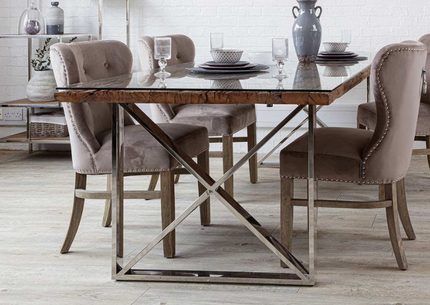 reclaimed wood dining table with polished silver crossed legs and glass top