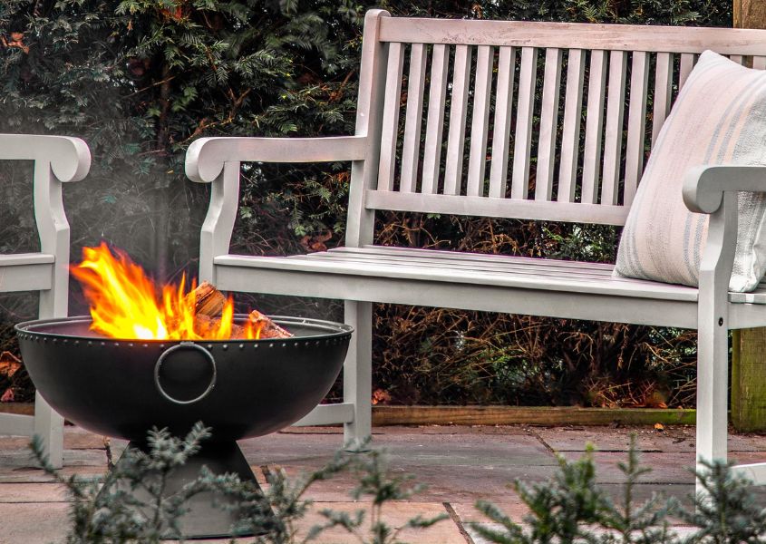 wooden garden bench with iron fire pit
