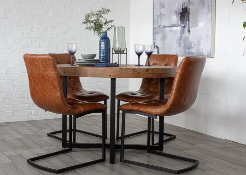 industrial round dining table with brown leather dining chairs