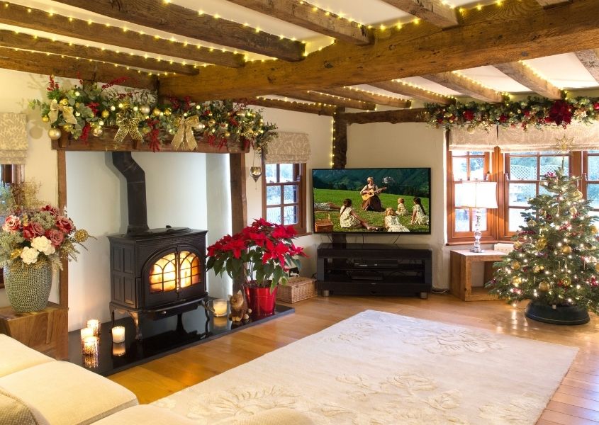 living room decorated for Christmas with wood burner and rustic furniture