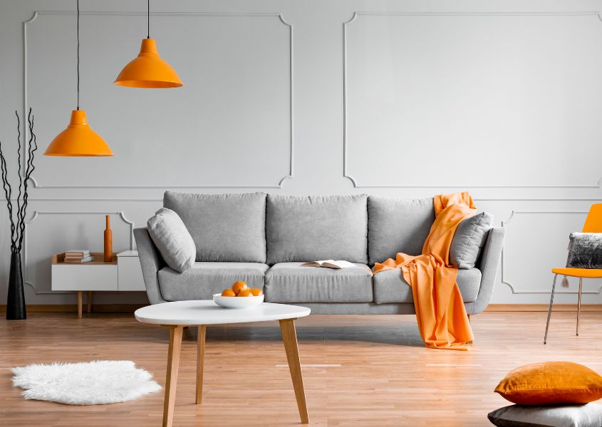 grey sofa with orange pendant lights