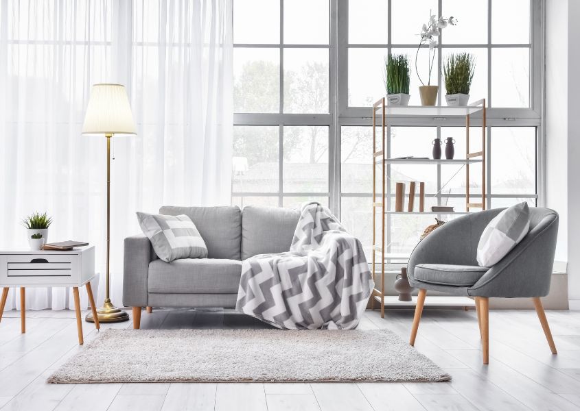 grey sofa with grey fabric armchair and white rug