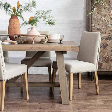 Wooden trestle table with cream fabric dining chairs