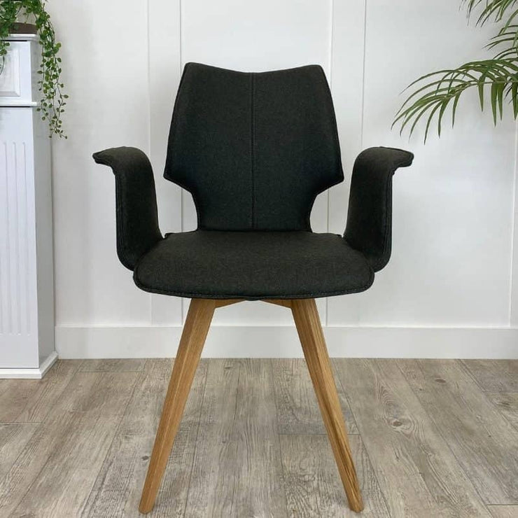 Upholstered dining chair in green with wooden legs