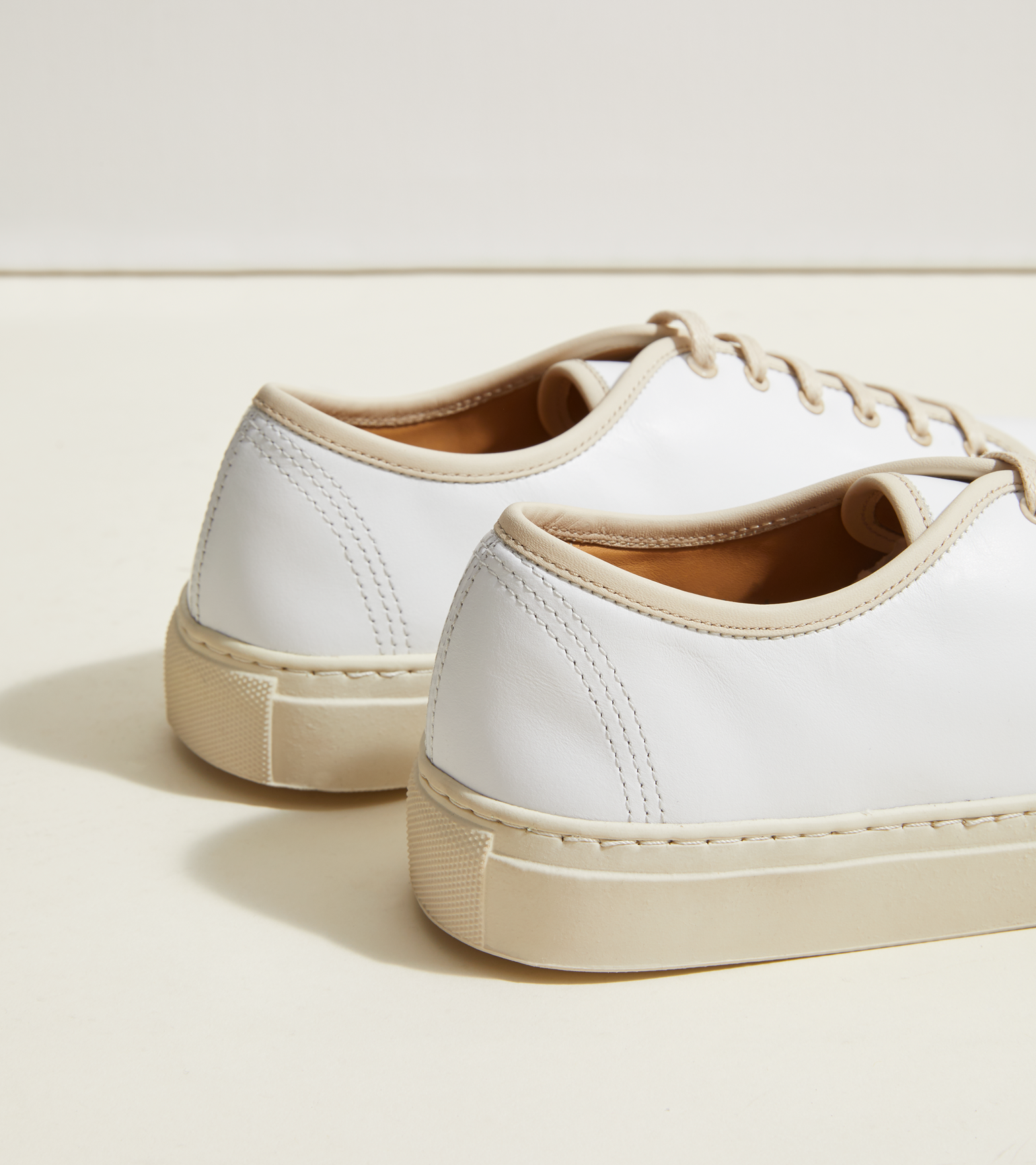 white leather sneakers with gum sole