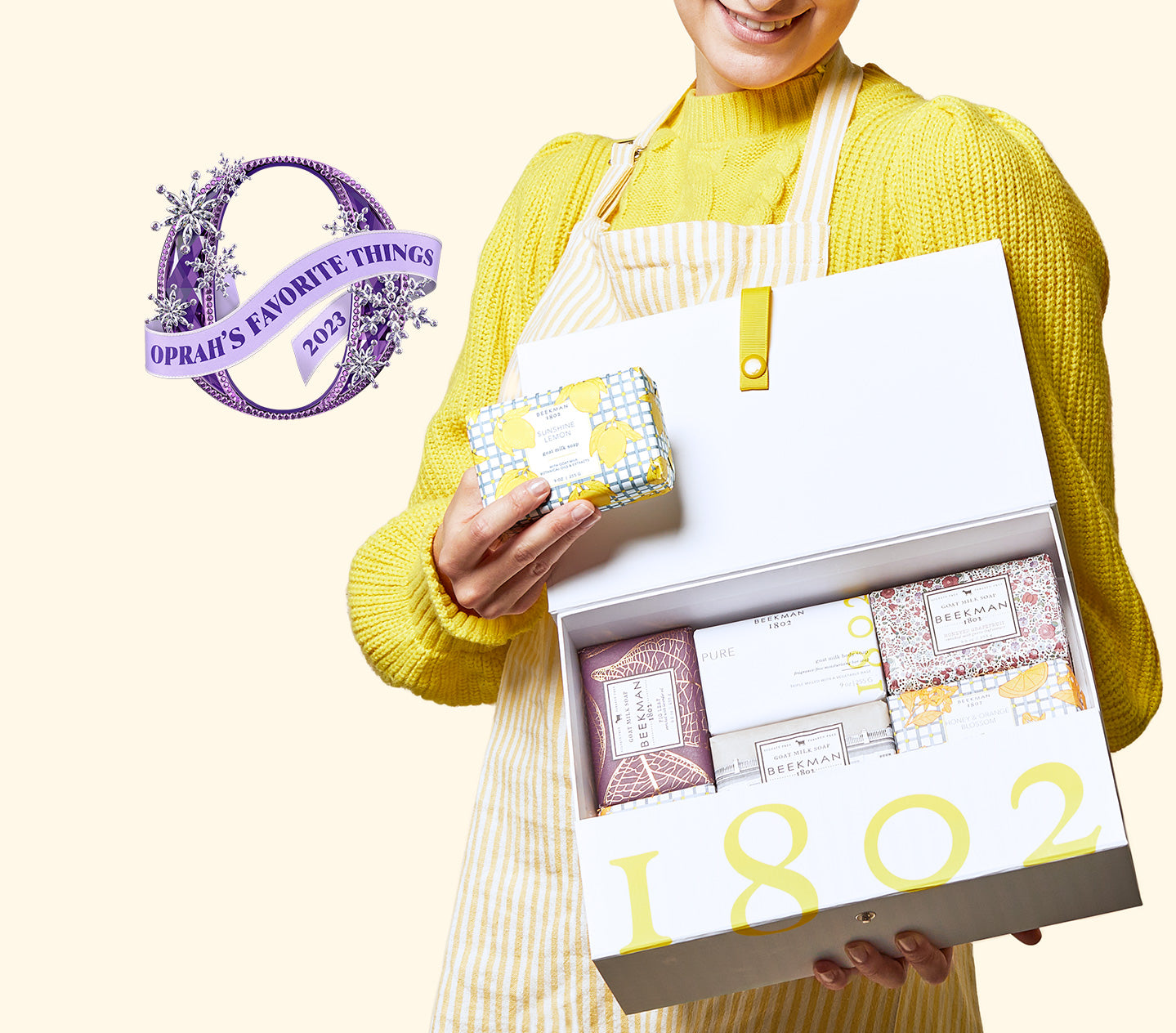 Image of model holding Beekman 1802's Sweet to be kind 8pc bar soap set in the box next to the purple "Oprah's Favorite Things 2023" logo on the right.