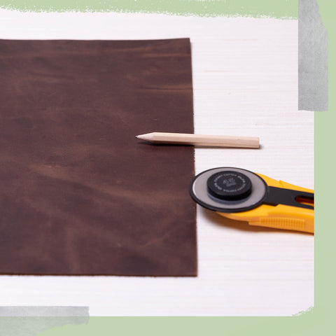 Leather, a pencil, and a rotary cutter.