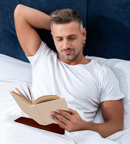man using teckpad while reading in bed