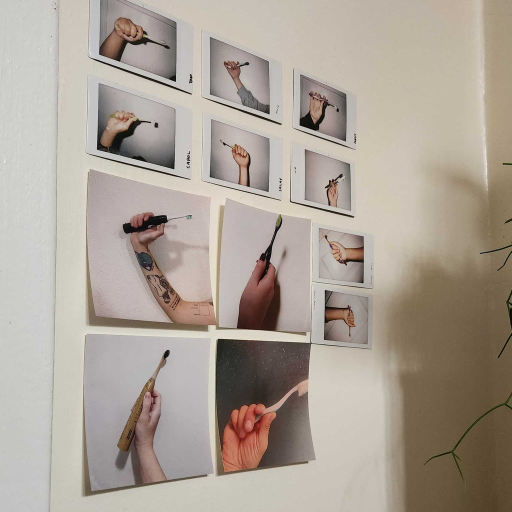 A grid of polaroid photos taped to a wall of how people hold their toothbrushes
