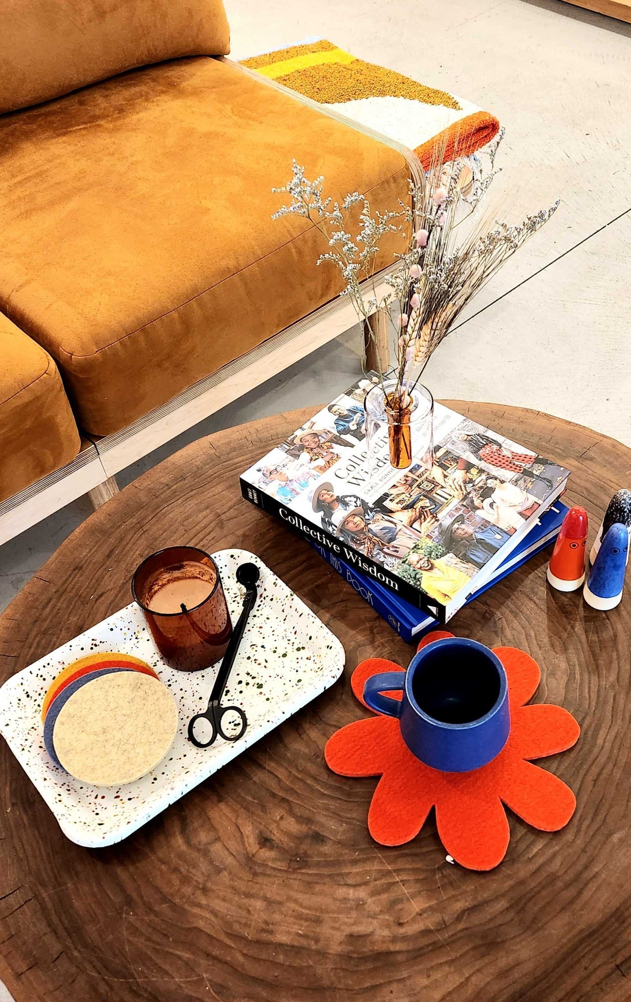 A coffee table decorated with items from Rare Device; coasters, mugs, vases and candles