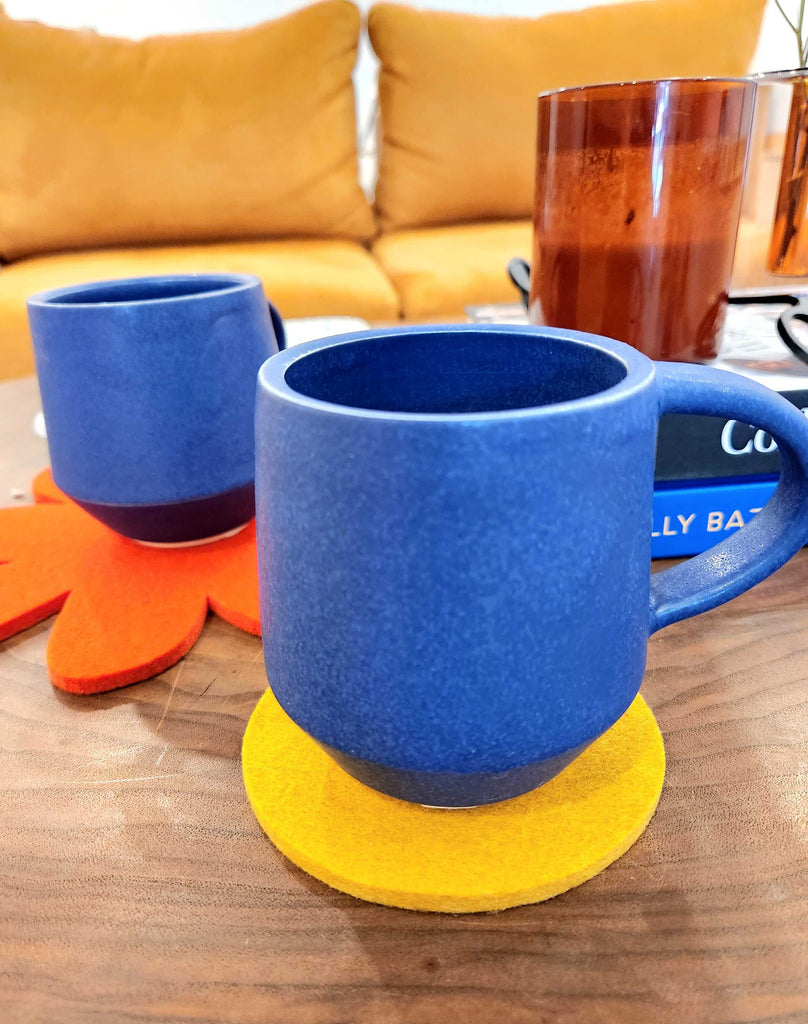 East Clay Ceramic mugs in indigo on top of felted wool coasters from Graf Lantz