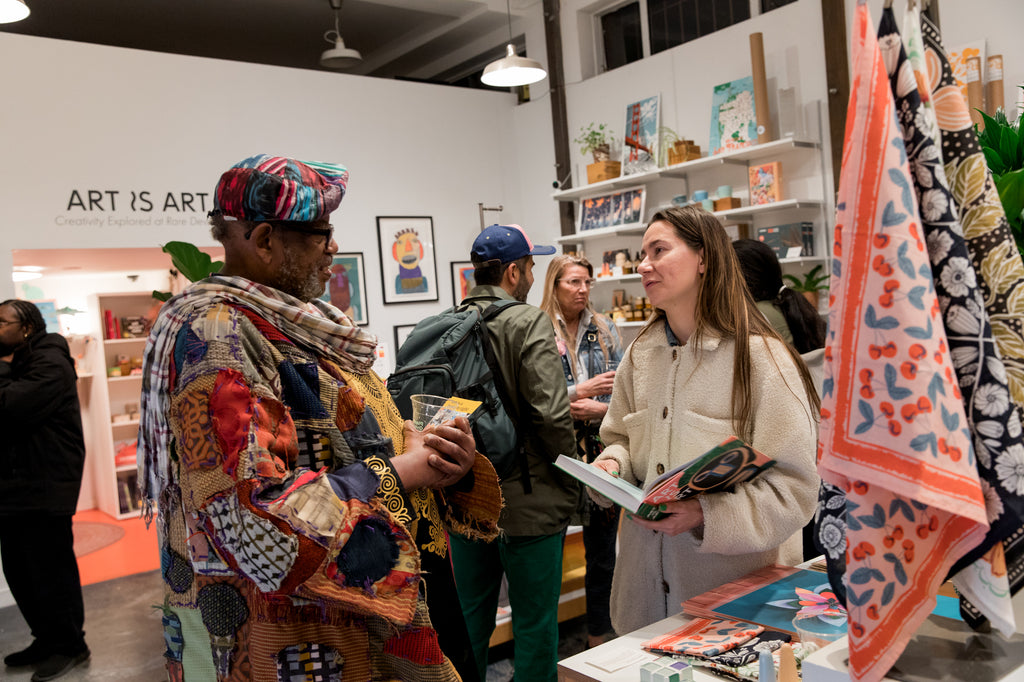 Artist Vincent Jackson chatting with an Art is Art gallery attendee