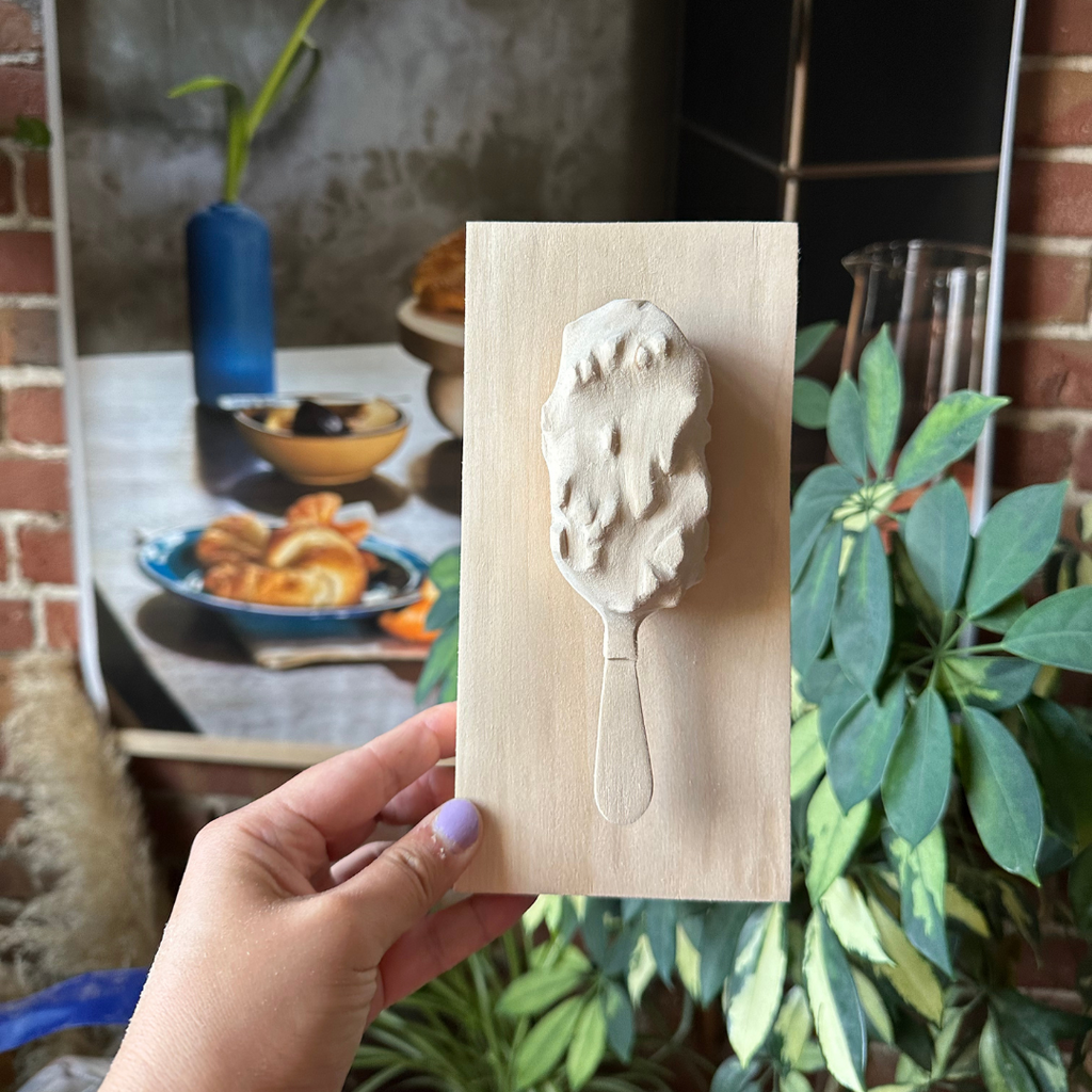 A relief carving of a ice cream bar from Third Culture by Melanie Abrantes