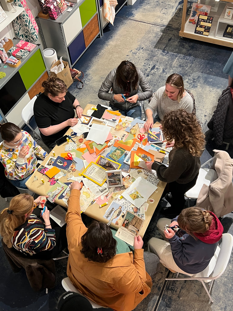 Overhead view of a group making collages with colorful scraps of paper