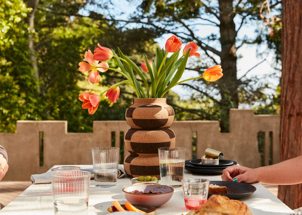 A cork vase as part of a dinner setting from Melanie Abrantes Designs