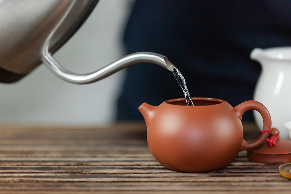 water being pouring into tea pot