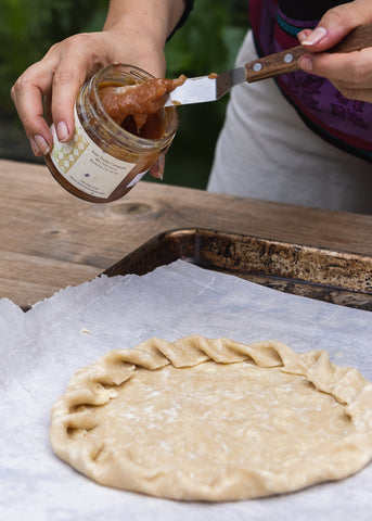 spreading jam in pie