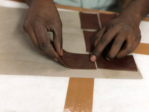 leathercrafter in india with pieces of leather