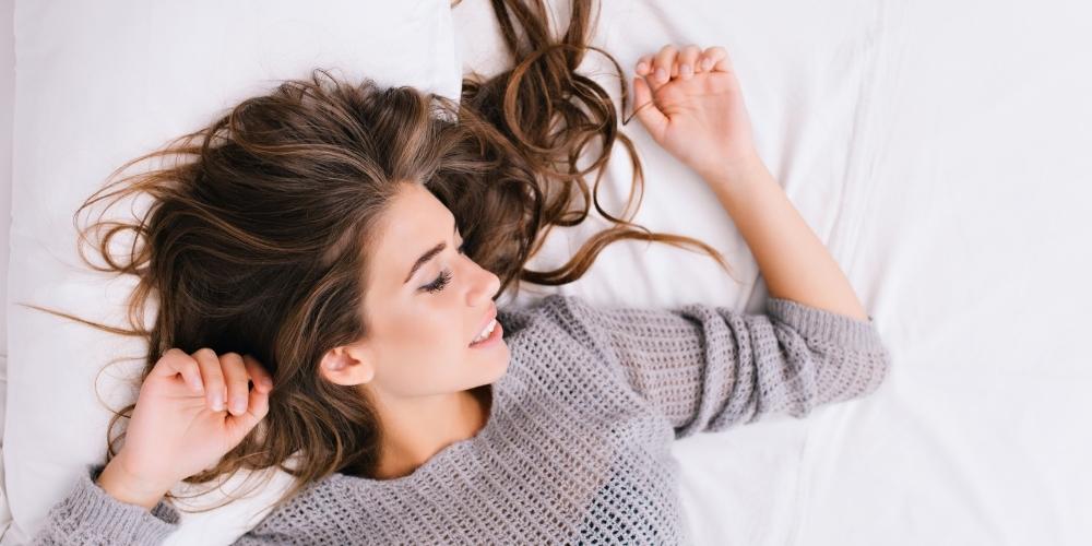 woman laying on pillowcase with nice hair