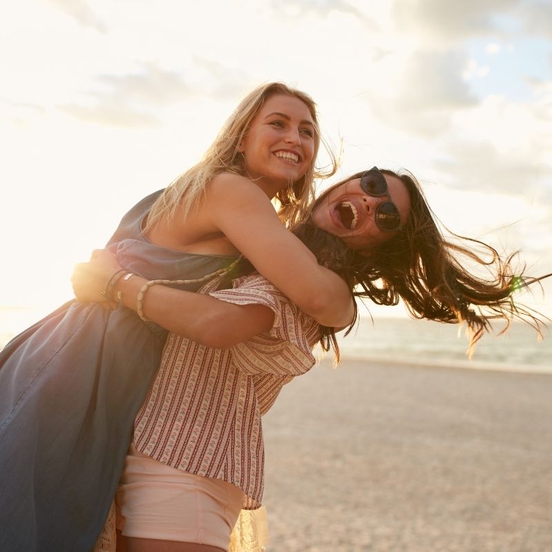 besties hugging on the beach