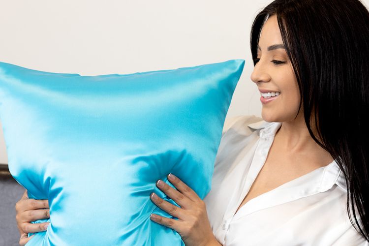 woman with aqua silk pillowcase with smooth surface