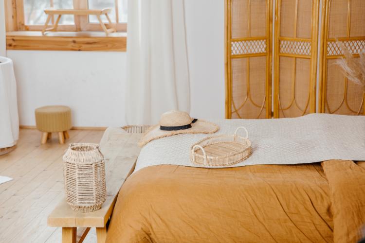 earth tone style bamboo bedding table at foot of bed