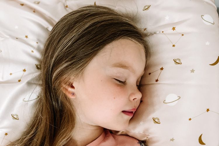 little girl laying on silk