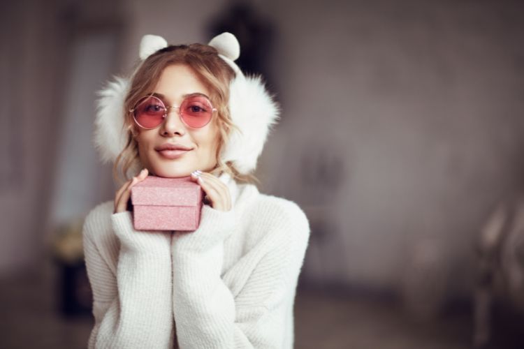 woman with cat ears holding a gift