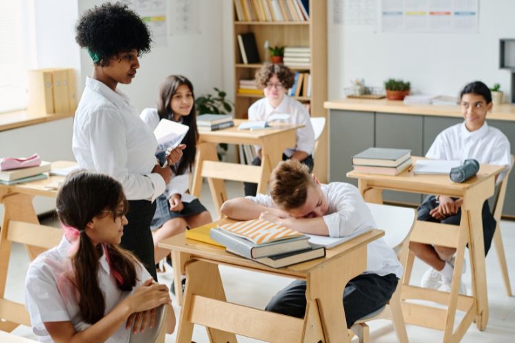 child in light sleep in the classroom