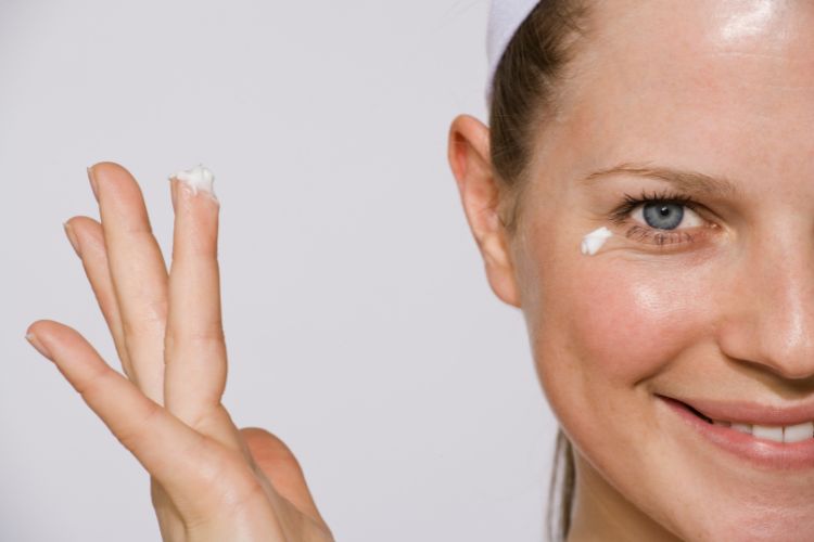 woman wearing eye cream