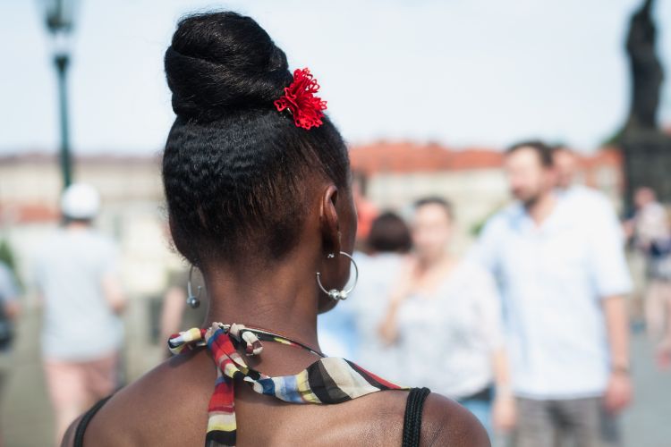 hair worn in a chic bun on top of head