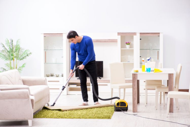 man vacuuming