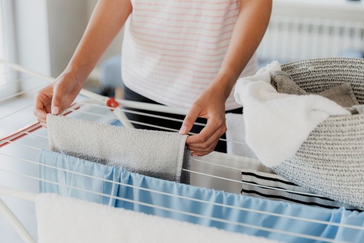 clean towel and wet items on a drying rack