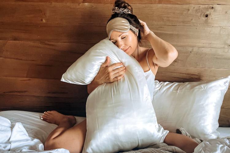 woman enjoying silk pillowcase and sleep mask